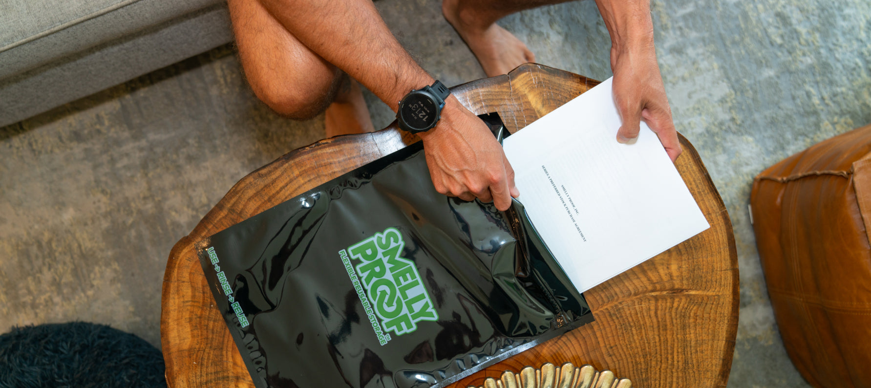 Man Putting Sensitive Documents Into a Black Flat Odor Proof Ziplocking Bag for Protection